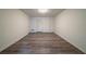 Room featuring wood-look flooring, multiple doors, and a ceiling light at 1119 Summer Brook Rd, Atlanta, GA 30349