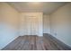 Bedroom featuring a large closet, wood-look floors, and a neutral color palette at 1119 Summer Brook Rd, Atlanta, GA 30349