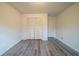 Bright bedroom with hardwood floors, neutral walls, and a closet for storage at 1119 Summer Brook Rd, Atlanta, GA 30349