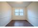 Clean dining room with wainscoting, wood-look flooring, and large windows to allow for natural light at 1119 Summer Brook Rd, Atlanta, GA 30349