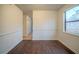 Dining room featuring wainscoting, wood-look flooring, and natural light from a large window at 1119 Summer Brook Rd, Atlanta, GA 30349
