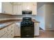 Functional kitchen with white cabinetry, laminate countertops, and appliances at 1119 Summer Brook Rd, Atlanta, GA 30349