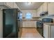 Classic kitchen featuring white cabinets, laminate countertops, and standard appliances at 1119 Summer Brook Rd, Atlanta, GA 30349