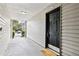 Covered entryway with black door and 