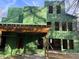Exterior view of a modern home under construction, featuring green sheathing and open window frames at 3534 Rockhaven Ne Cir, Atlanta, GA 30324