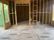 Unfinished living room showcasing stud framing, large windows, and plumbing lines for future construction at 3534 Rockhaven Ne Cir, Atlanta, GA 30324