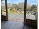 Unfinished living room featuring stud framing and windows with views of houses and mature trees in the surrounding neighborhood at 3534 Rockhaven Ne Cir, Atlanta, GA 30324