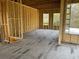 Unfinished living room showcasing stud framing, large windows, and outdoor views of the surrounding landscape at 3534 Rockhaven Ne Cir, Atlanta, GA 30324
