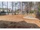 A spacious backyard features a stone fire pit and surrounding wooded area at 2107 Kendall Close Nw, Acworth, GA 30102