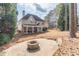 Spacious backyard features a patio with a fire pit and view of the back of the house at 2107 Kendall Close Nw, Acworth, GA 30102