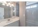 Bathroom featuring a sink, mirror, and a shower-tub combination with white tile at 2107 Kendall Close Nw, Acworth, GA 30102