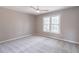 A bright bedroom features neutral walls, soft carpet, a ceiling fan, and a window at 2107 Kendall Close Nw, Acworth, GA 30102