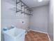 Laundry room with utility sink, wire shelving, and terra cotta tile floor at 2107 Kendall Close Nw, Acworth, GA 30102