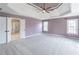 Large main bedroom with tray ceiling, carpeting, and access to ensuite bathroom at 2107 Kendall Close Nw, Acworth, GA 30102