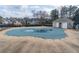 A community pool covered for the off-season with a clubhouse and homes nearby at 2107 Kendall Close Nw, Acworth, GA 30102