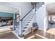 Elegant staircase with dark wood accents, neutral carpet runner, and a rustic bench at 2107 Kendall Close Nw, Acworth, GA 30102