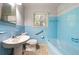 Bathroom with blue tile, bathtub, and pedestal sink at 241 W Simon Nw Ter, Atlanta, GA 30318