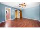 Primary bedroom with light blue walls, hardwood floors and en-suite bathroom at 241 W Simon Nw Ter, Atlanta, GA 30318