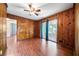 Living room with wood-paneled walls, hardwood floors, and sliding glass doors at 241 W Simon Nw Ter, Atlanta, GA 30318