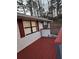 Red stained deck with a view of the wooded backyard at 3566 Carry Ct, Snellville, GA 30039