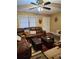 Comfortable living room with a ceiling fan, featuring a leather sofa, a decorative rug, and natural lighting at 3566 Carry Ct, Snellville, GA 30039