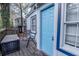 Charming back porch with seating and a bright blue door, creating an inviting outdoor space at 953 Garibaldi Sw St, Atlanta, GA 30310