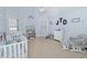 Bedroom with a crib, rocker, and plenty of storage at 1553 Rolling Meadows Dr, Mcdonough, GA 30253