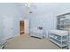 Bedroom with crib, changing table, and musical wall decor at 1553 Rolling Meadows Dr, Mcdonough, GA 30253