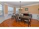 Formal dining room with hardwood floors, chandelier, and bay window at 1553 Rolling Meadows Dr, Mcdonough, GA 30253