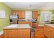 Kitchen with island, stainless steel appliances, and wood cabinets at 1553 Rolling Meadows Dr, Mcdonough, GA 30253