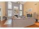 Two-story living room with hardwood floors, fireplace, and large windows at 1553 Rolling Meadows Dr, Mcdonough, GA 30253