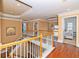 Bright upper hallway with hardwood floors and access to bedrooms at 1553 Rolling Meadows Dr, Mcdonough, GA 30253