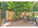 Private gated patio with a bistro set and lush landscaping at 5400 Roswell Rd # E2, Atlanta, GA 30342