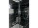 Bathroom with black marble tile and glass shower at 911 David Dr, Lawrenceville, GA 30046