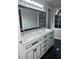 Double vanity bathroom with white cabinets and black accents at 911 David Dr, Lawrenceville, GA 30046