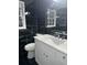 Bathroom with white vanity, black tile, and quartz countertop at 911 David Dr, Lawrenceville, GA 30046
