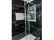 Modern bathroom with black marble tile and a white vanity at 911 David Dr, Lawrenceville, GA 30046