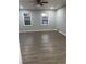 Spacious bedroom with gray walls, wood-look floors, and two windows at 911 David Dr, Lawrenceville, GA 30046