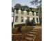 Two story home with white siding, black trim, and stone steps leading to the entrance at 911 David Dr, Lawrenceville, GA 30046