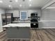 Modern kitchen with gray cabinets, white countertops, and a large island at 911 David Dr, Lawrenceville, GA 30046