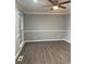 Bright living room with gray walls, wood-look floors, and ceiling fan at 911 David Dr, Lawrenceville, GA 30046