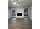 Spacious living room featuring hardwood floors, fireplace, and large windows at 911 David Dr, Lawrenceville, GA 30046