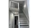 Elegant staircase with white risers and gray walls, leading to upper level at 911 David Dr, Lawrenceville, GA 30046