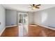 Spacious bedroom with hardwood floors and sliding glass doors to patio at 213 Pine Crest Dr, Cumming, GA 30040