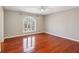Spacious bedroom with hardwood floors and large arched window at 213 Pine Crest Dr, Cumming, GA 30040