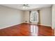 Bright bedroom featuring hardwood floors and an arched window at 213 Pine Crest Dr, Cumming, GA 30040