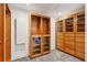 Spacious walk-in closet with custom built-ins and laundry area at 213 Pine Crest Dr, Cumming, GA 30040
