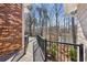 Outdoor deck overlooking lake with black metal railing and treed lot views at 213 Pine Crest Dr, Cumming, GA 30040