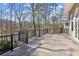 Large deck overlooking the lake with a wooden surface and metal railings at 213 Pine Crest Dr, Cumming, GA 30040