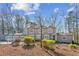 Elegant two-story home with a three car garage and manicured landscaping at 213 Pine Crest Dr, Cumming, GA 30040
